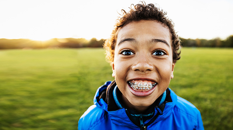 boy with braces smiling