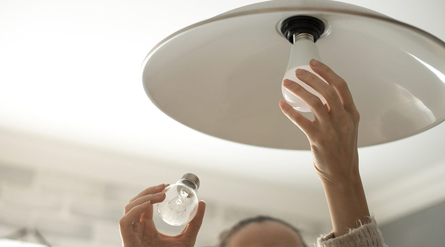 person changing light bulb