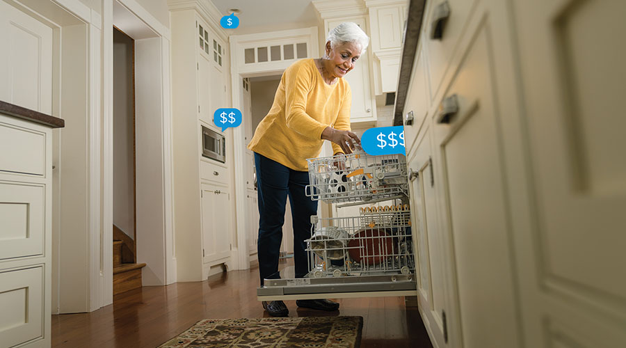 elder woman loading dishwasher