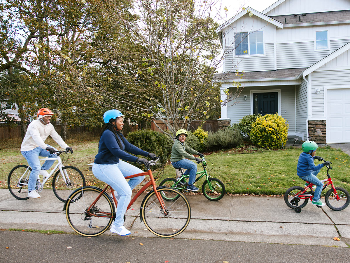 family riding bikes in neighborhood