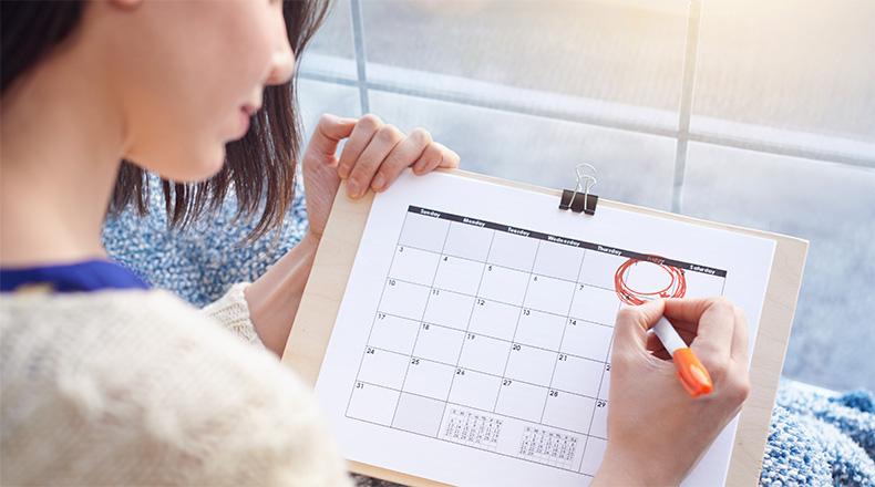 woman circling a date on a calendar