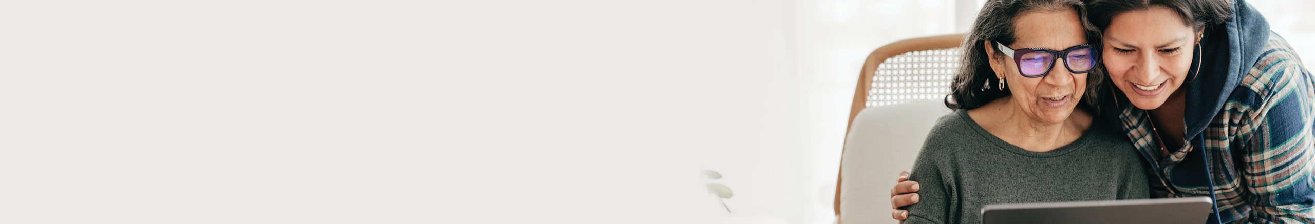 mother and daughter looking at laptop