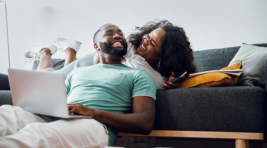 couple sitting in the living room smiling