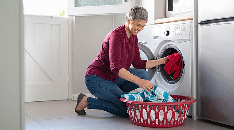 woman taking clothing out of dryer